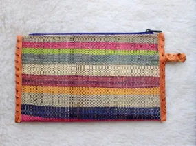 muted multi-colored striped raffia woven clutch with leather trim